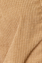 Close up of the textured camel jacket fabric