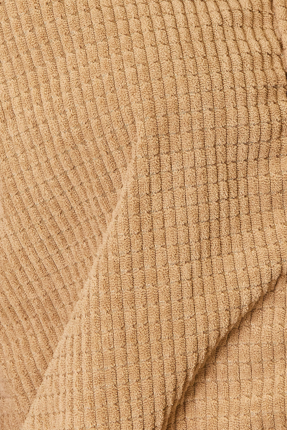 Close up of the textured camel jacket fabric