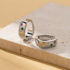 Silver tone huggie hoop earrings with multicolor zircon