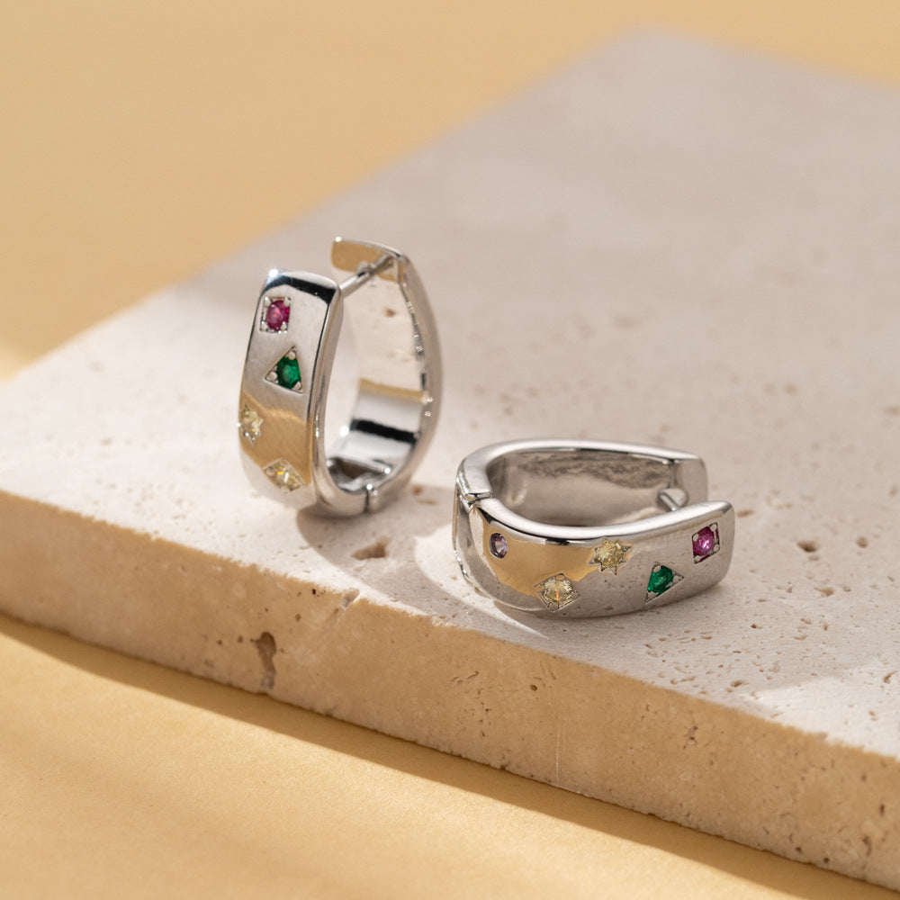 Silver tone huggie hoop earrings with multicolor zircon