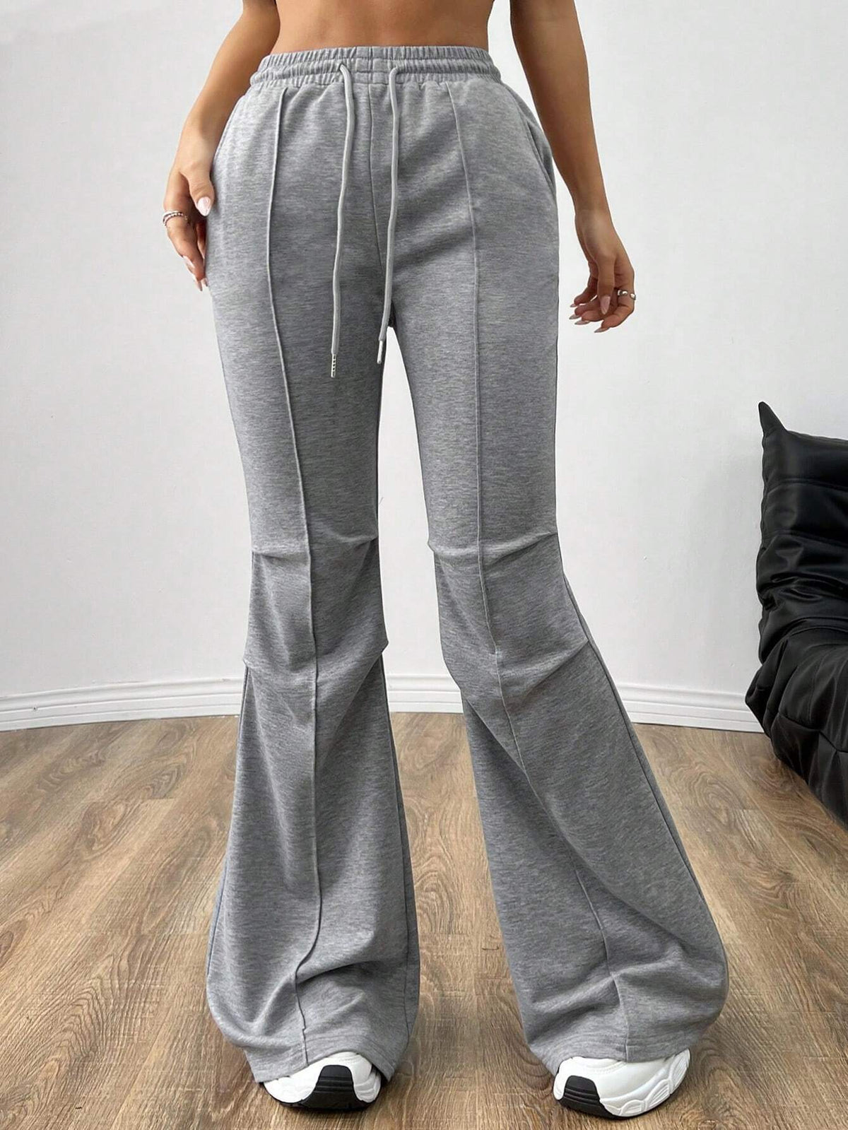 Gray flare sweatpants with drawstring waist and front seams