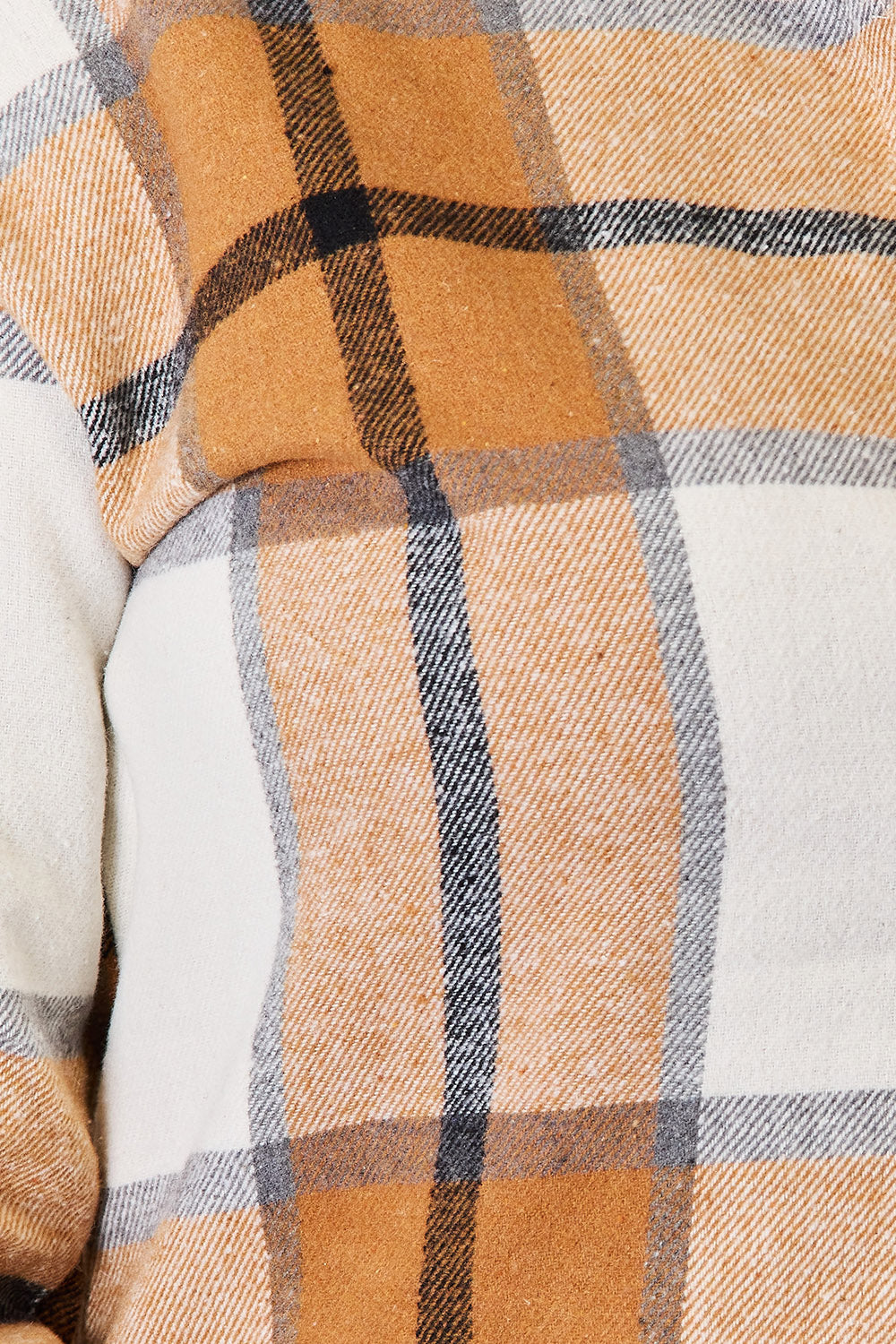 Close up of the tan, orange and white plaid fabric