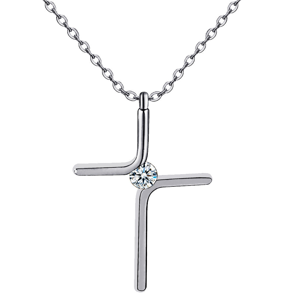 Silver tone cross pendant necklace with a small stone