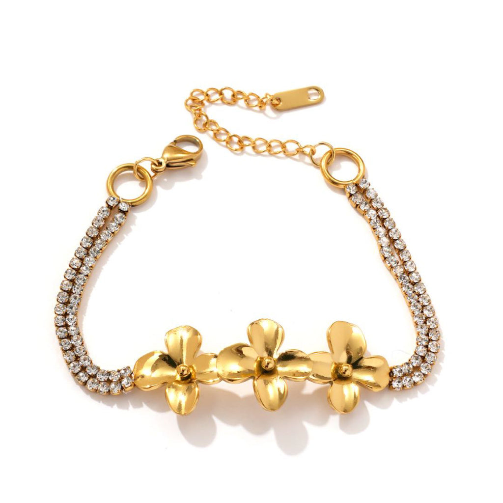 Gold tone flower bracelet on a white background