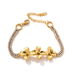 Gold tone flower bracelet on a white background