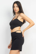 Black crop tank and skirt with side cutout, angled view