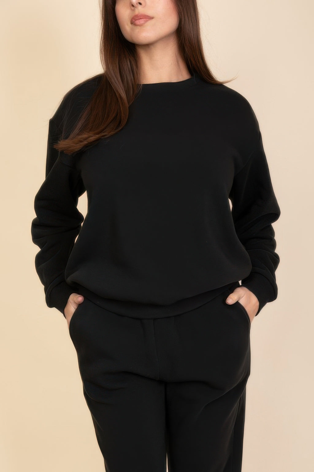 Black fleece crewneck sweatshirt, hand in pocket view