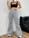 Gray flare sweatpants styled with a black crop top