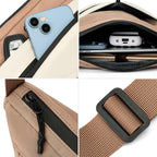 Close-up of the zipper pull, front pocket and strap buckle on the crescent crossbody bag
