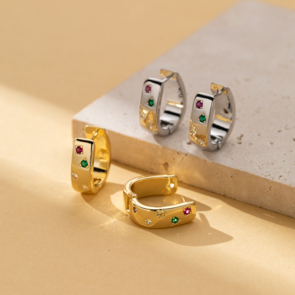 Gold tone and silver tone huggie hoop earrings with colored stones